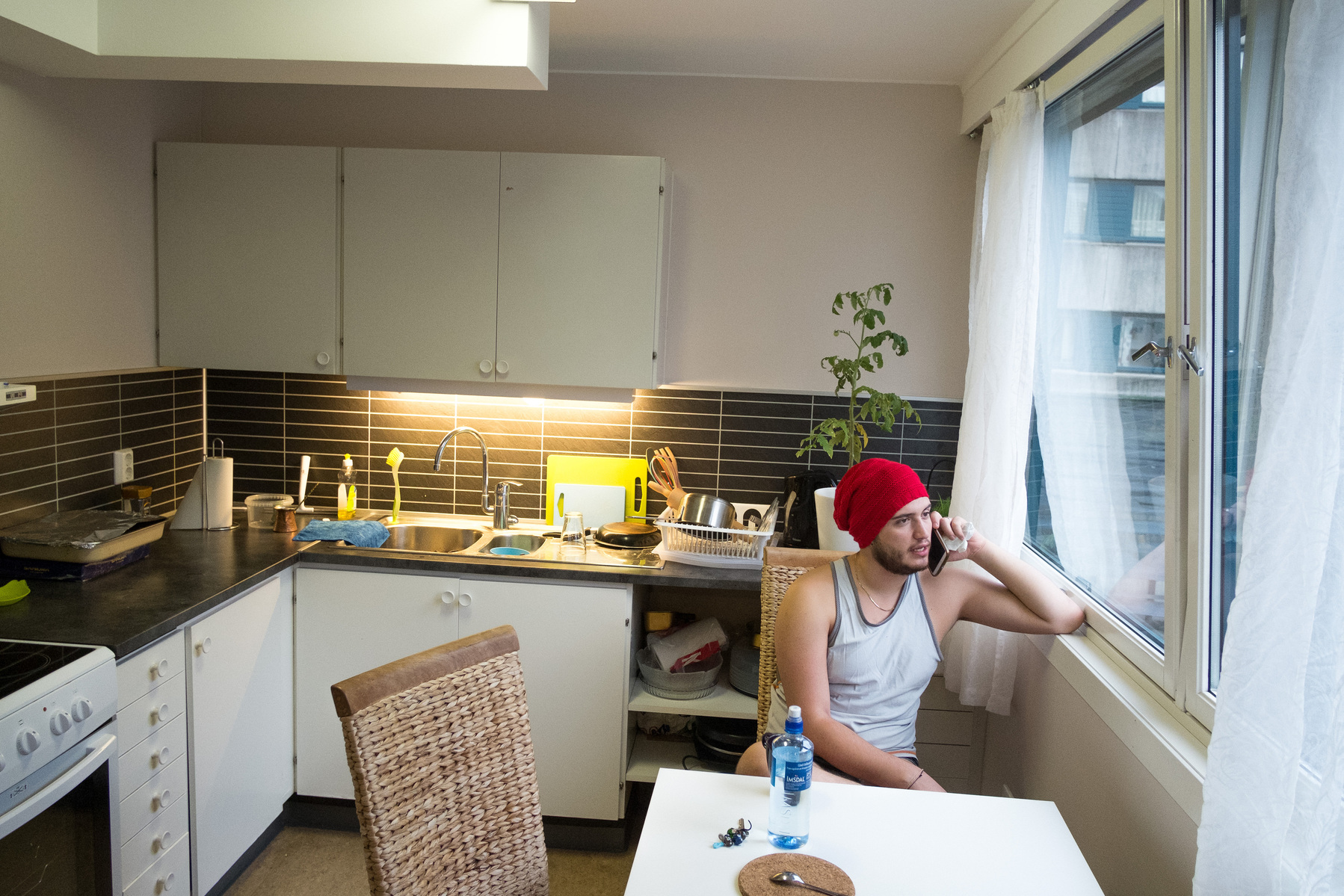 Omar chats with his family and relatives the morning after arriving in Bergen, Norway, from the kitchen of his apartment.