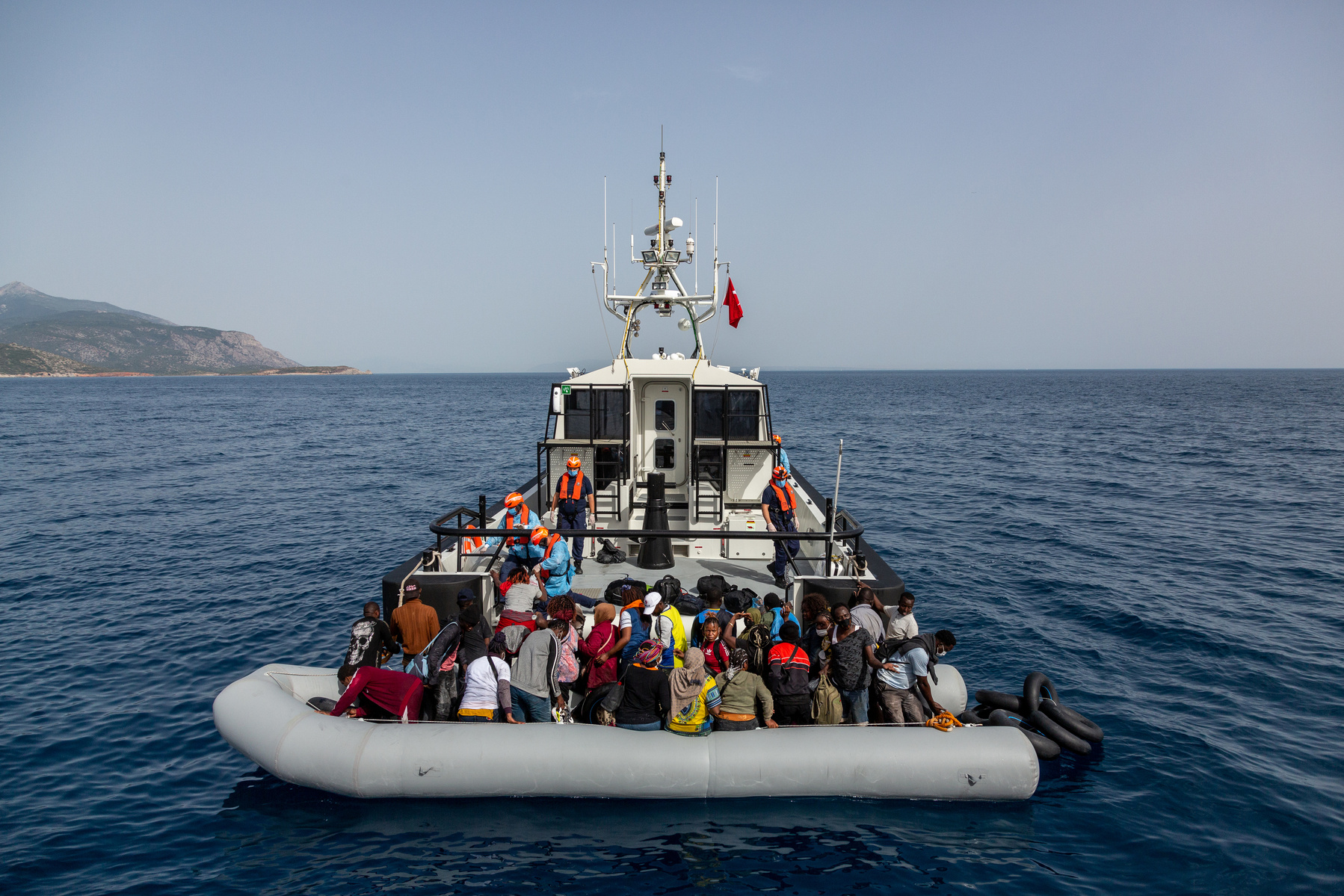 Europe, Turkey, Kuşadası. An engineless rubber boat with 39 persons on board, from multiple sub Saharan African countries, being rescued by the Turkish coastguard after 17 hours at sea. They all claim to have been pushed back by the Greek coastguard, into