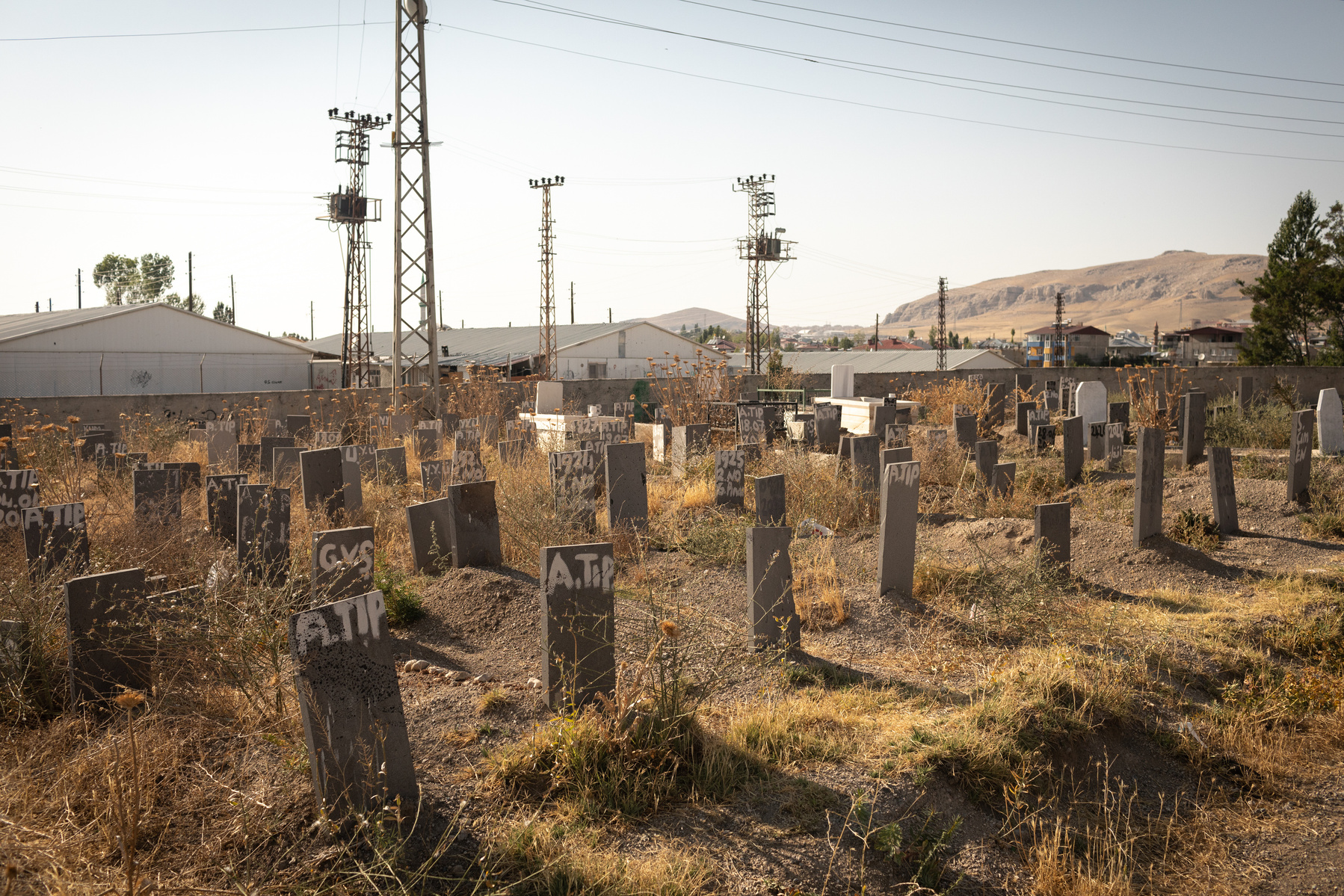 The graves of unidentified refugees and migrants, mostly from Afghanistan, in the 'cemetery of the unclaimed', in the city of Van, eastern Turkey. Van's location near Turkey's eastern border with Iran, has made it a key stop on the decades old migration r