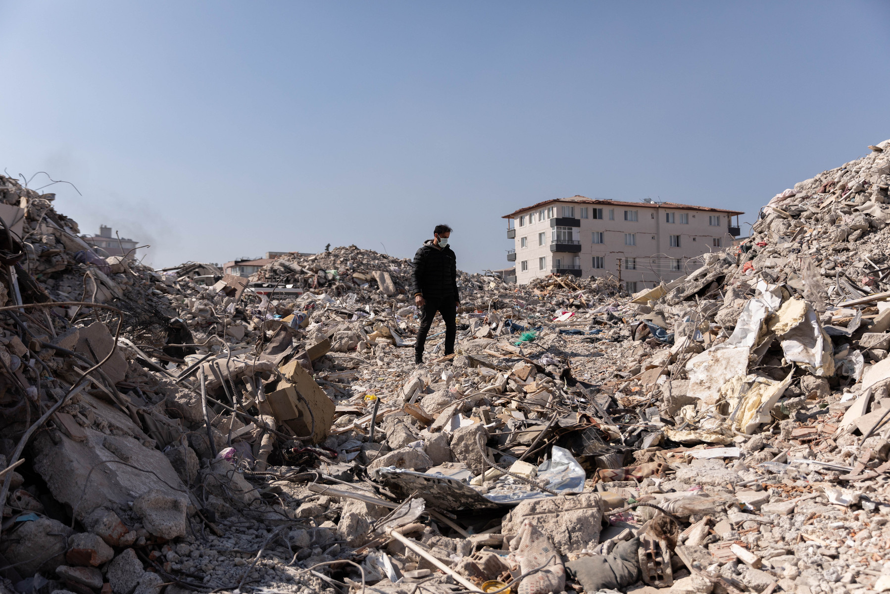 Searching through the rubble of his family home Enver Kuvvetli searches for any belongings left to salvage. Enver and his wife managed to escape and survived, but his mother, two brothers, sister, and two nephews all died as a result of the earthquake in