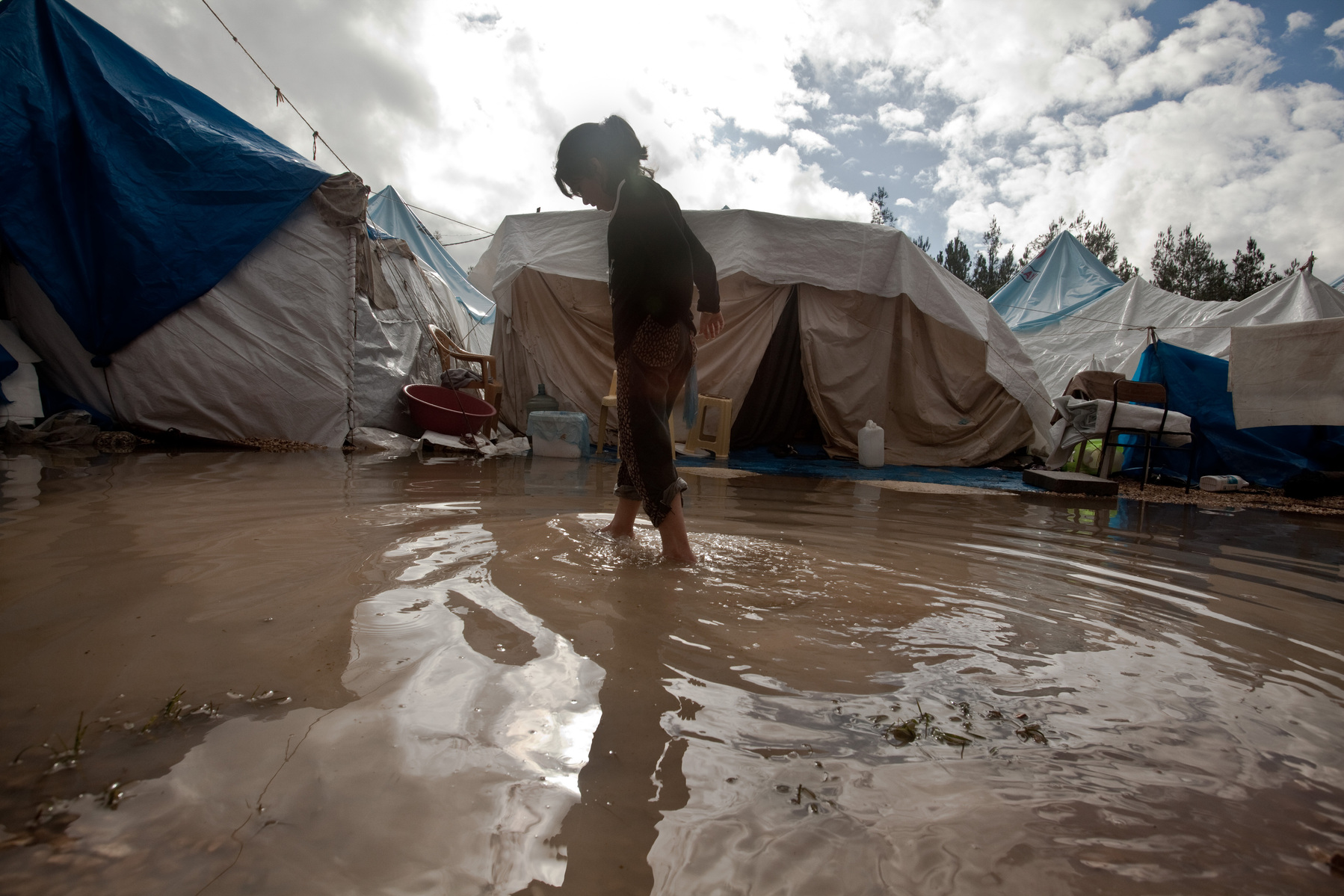 Rita wades through the flooded refugee camp to get to her tent. Yayladagi refugee camp for Syrians in southern Turkey. 12/21/2012 Bradley Secker for the Washington Post