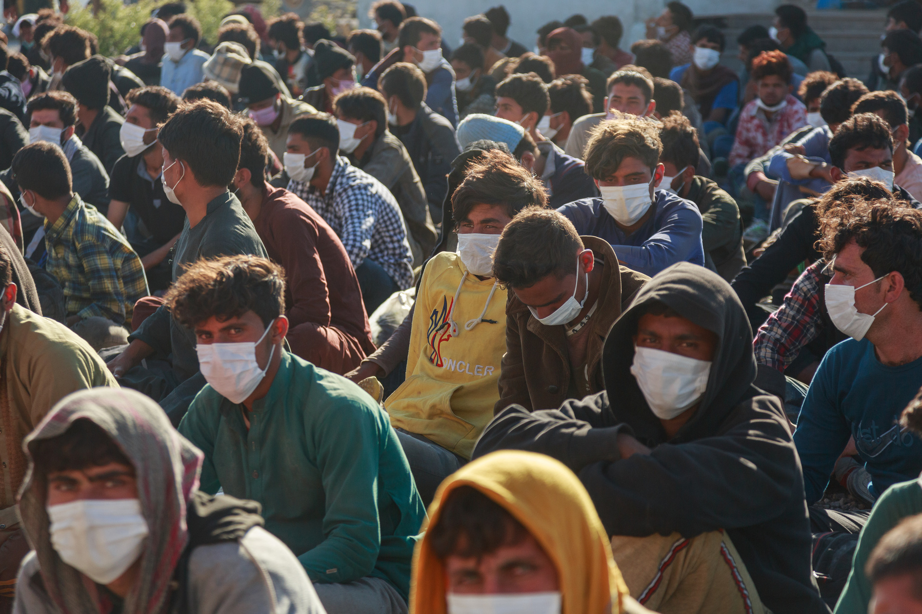 Approximately 400 migrants from Afghanistan, Pakistan, and Iran, who have been caught by the Turkish Jandarma and security services, await processing at a checkpoint near the town of Çaldiran, close to Turkey's border with Iran. Around 300 of these people