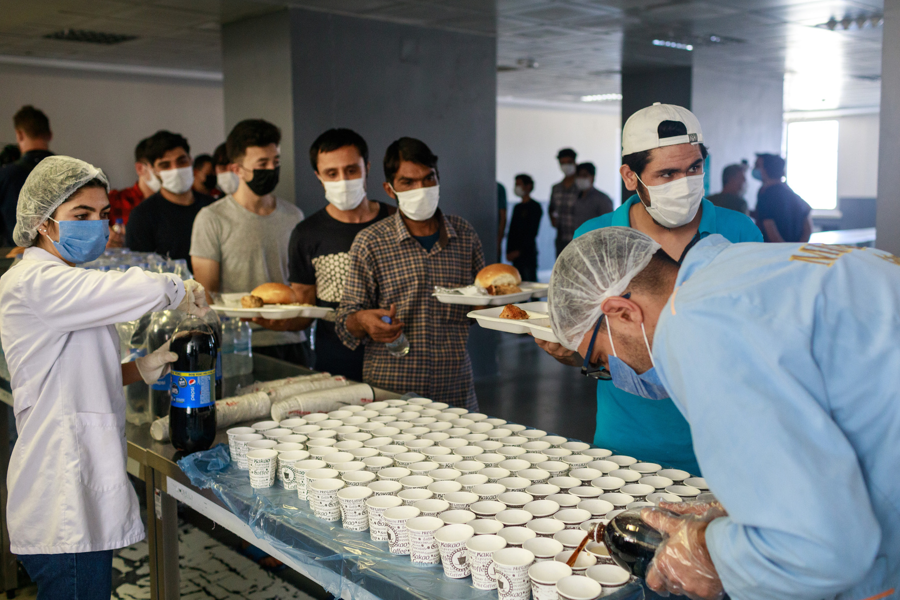 Turkey, Van. Afghan migrants at an immigration deportation removal centre near Van city, queue for lunch in the cantine. As the Taliban have taken control of Afghanistan, deportations are no longer taking place from Turkey, although they may continue in t