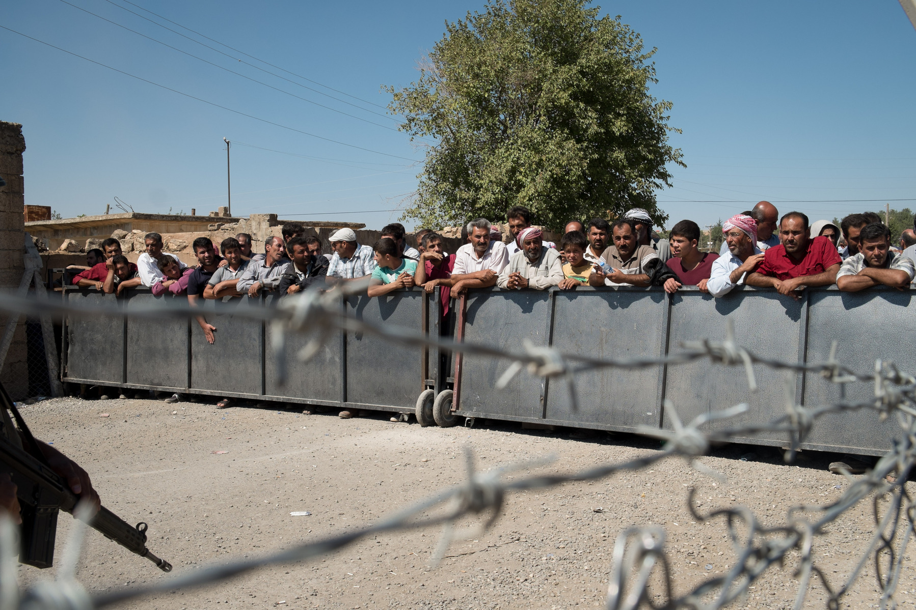 Syrian Kurdish refugees wait to return to their native Kobani, but Turkish authorities prevent them for some time at the Mürşitpınar border crossing in Şanlıurfa province, southern Turkey.