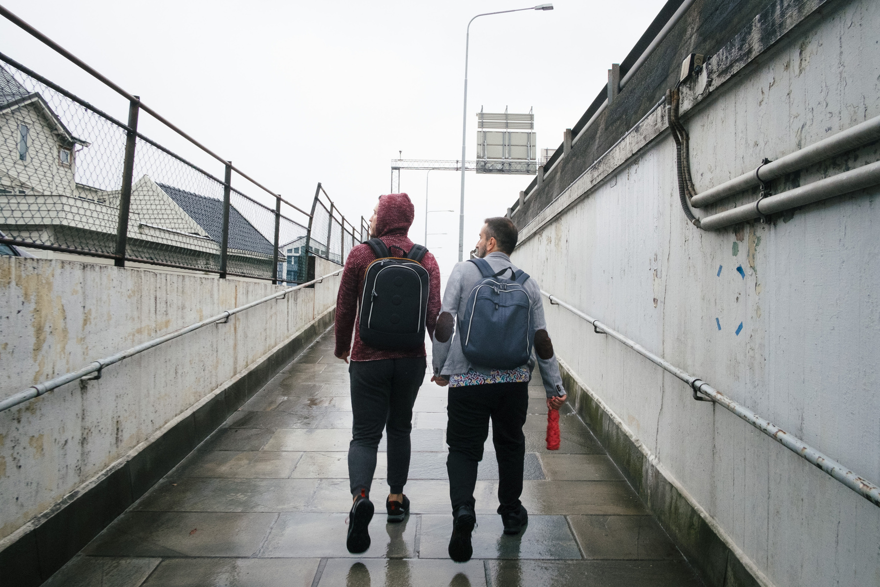 Omar (left) and Nader (right) walk to a hospital in Bergen, Norway, where Omar is tested for TB and other illnesses.