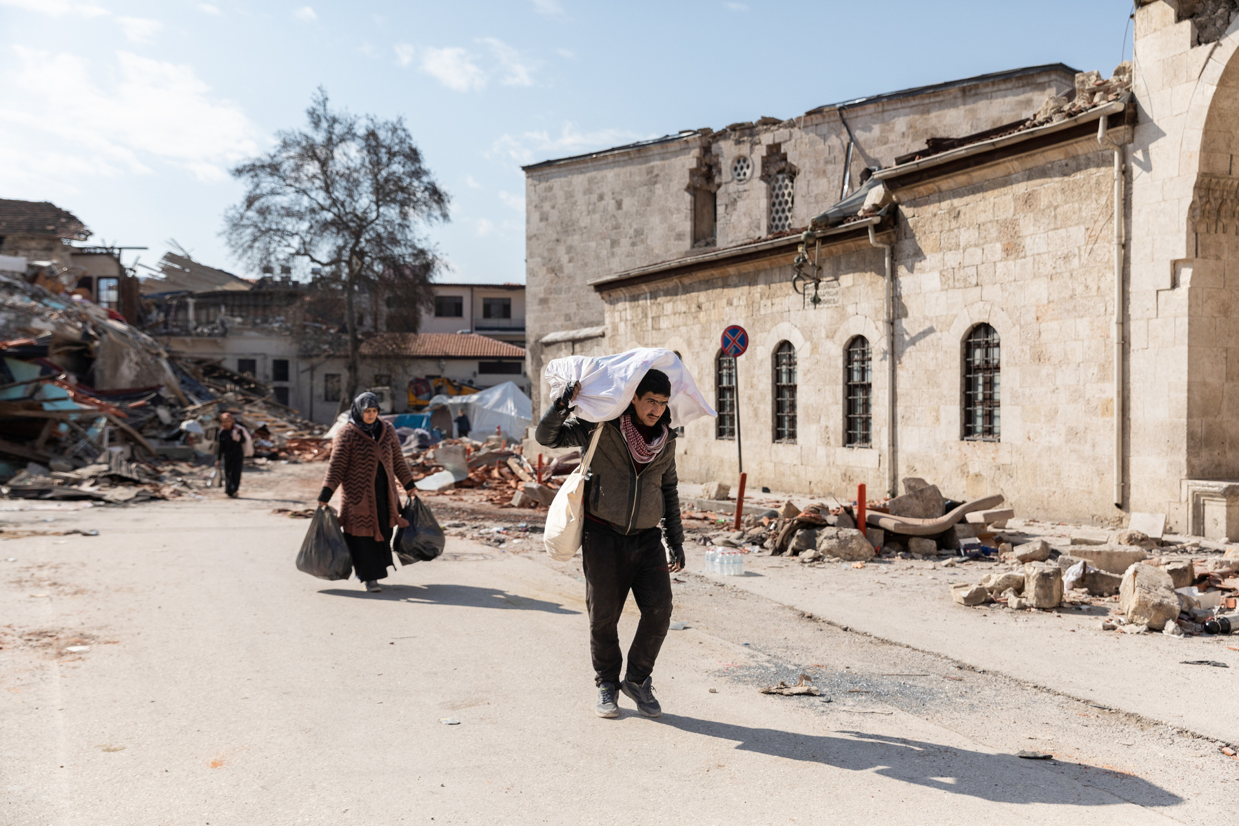 Passing by the ruins of the destroyed city of Antakya, southern Turkey, residents pass the bodies of victims retrieved from the rubble, and the ruins of their beloved city, as they navigate the accessible roads after the double earthquake in the south of