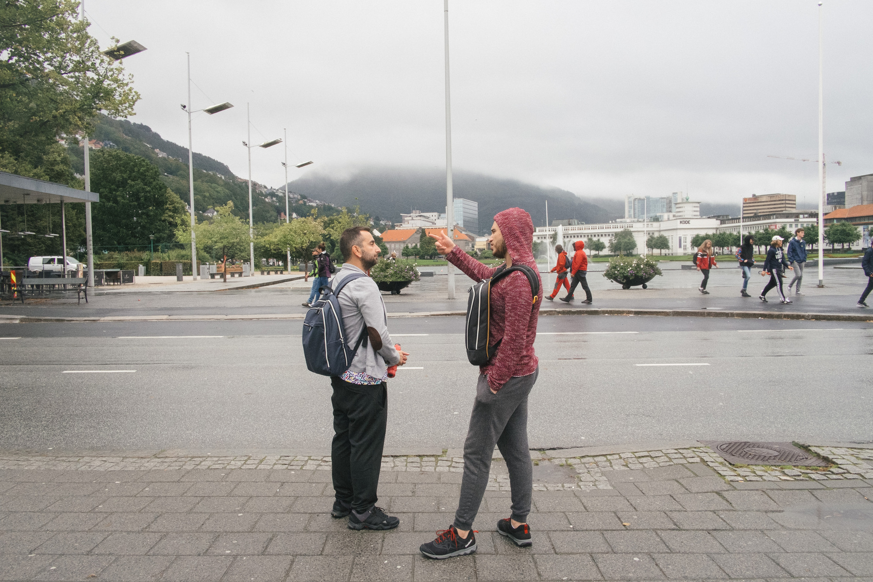 In downtown Bergen, Nader (left) explains to Omar (right) how to take the bus back home, and the general layout of the city on Omar's first morning in the country.