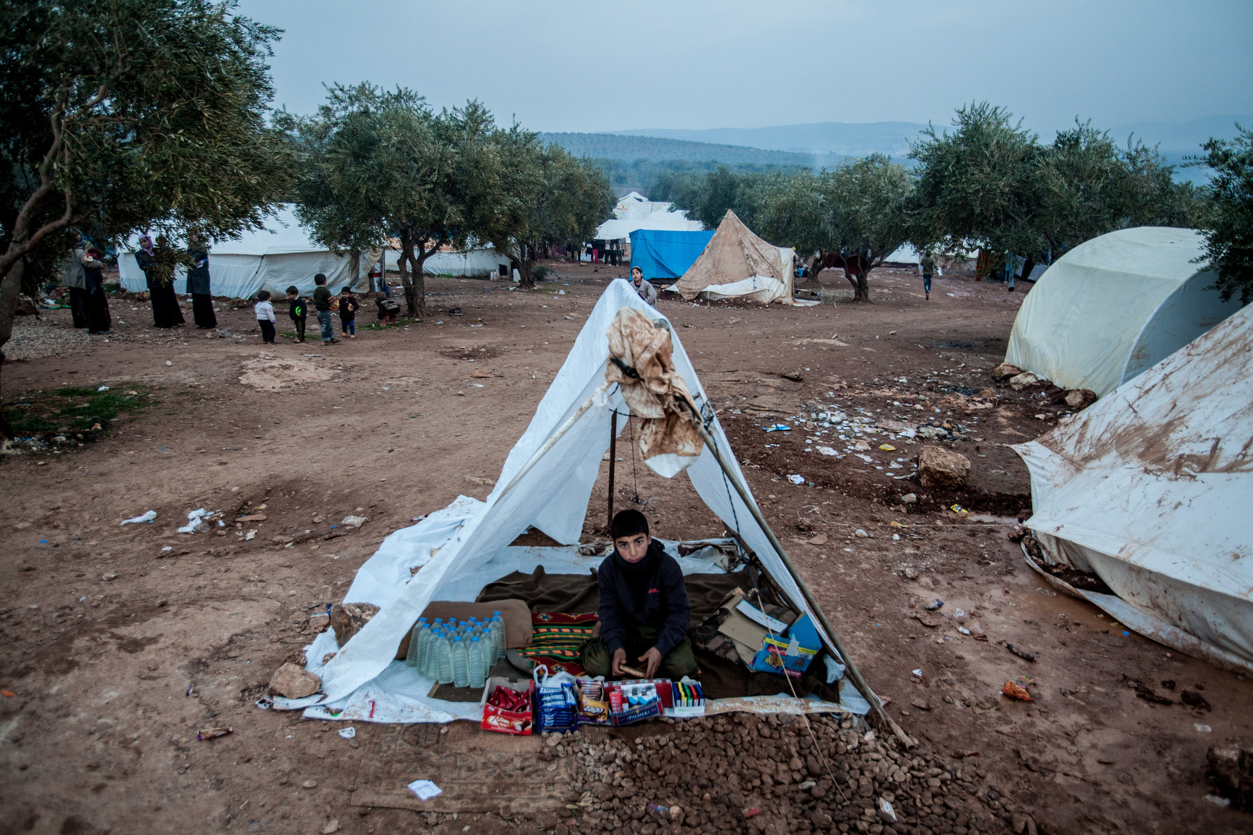 A boy sells food items at a temporary shop in Atmeh camp for around 12,000 IDP in north western Syria. 02/01/2013