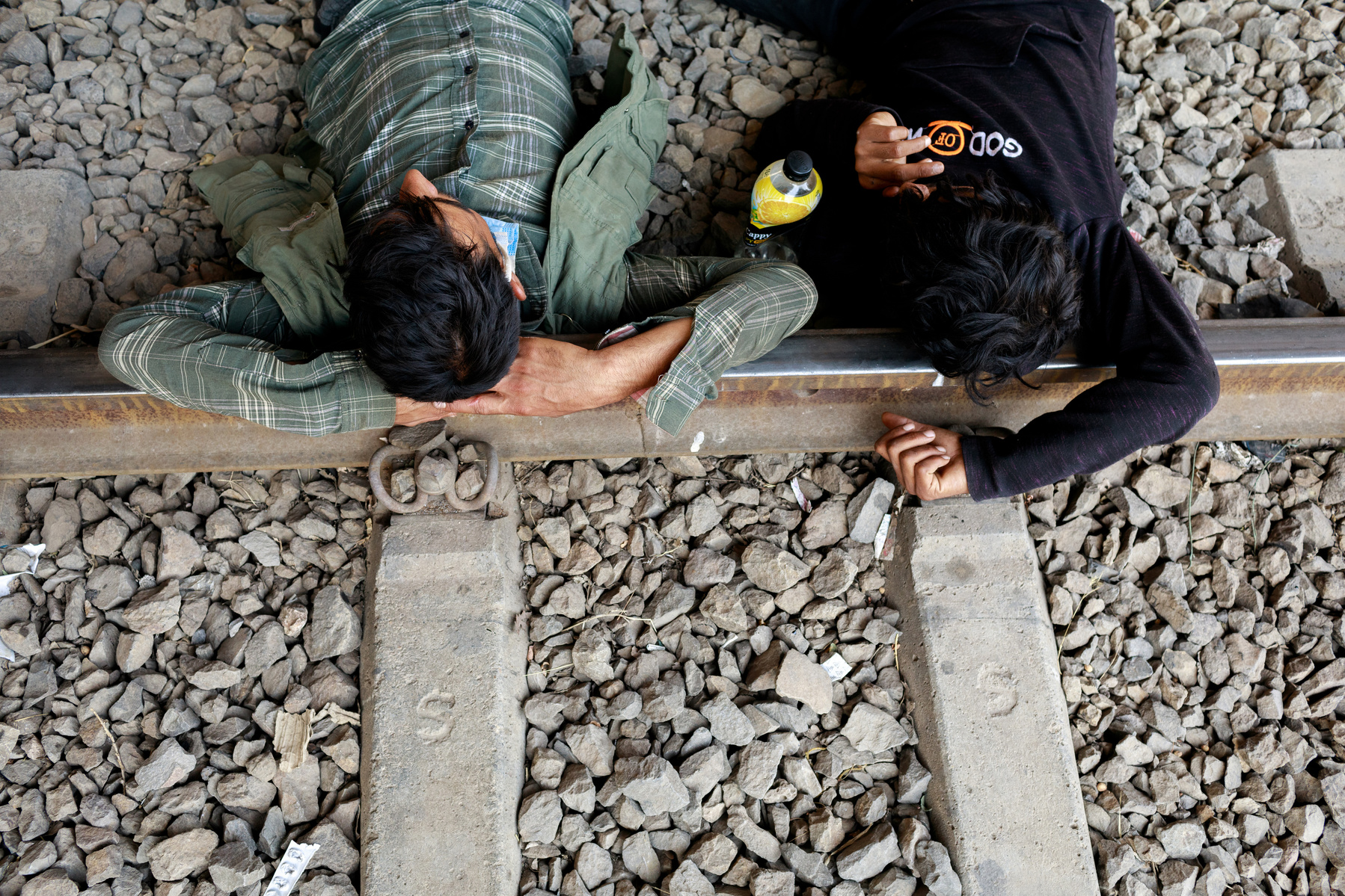 Afghan men sleep on a railway line in the city of Tatvan, eastern Turkey. After crossing into Turkey from Iran, the migrants have already been on the road for weeks, and still have a long journey ahead, to western Turkey and/or Europe, where many hope to