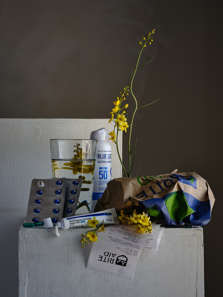 still life with sunscreen allergy remedies, spiny senna, water