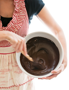 chocolate cake batter stirring with anthropologie apron