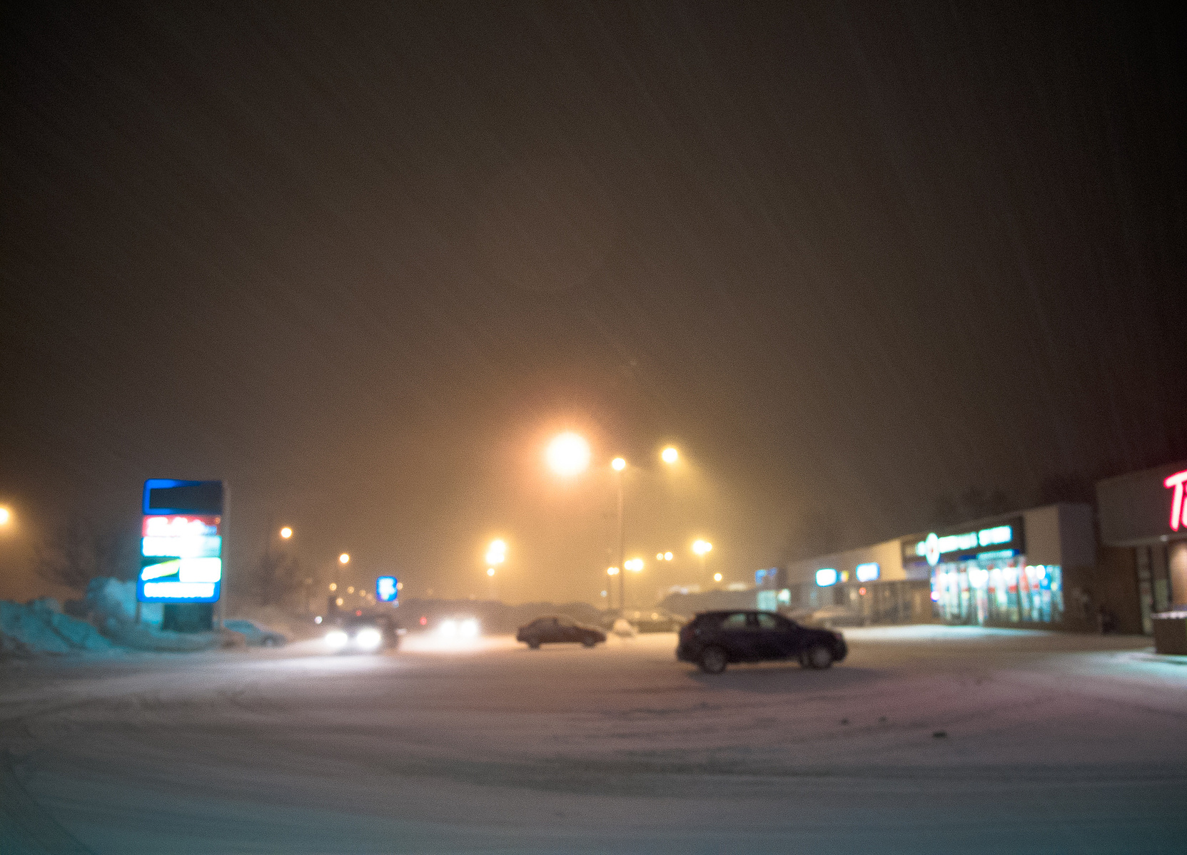 Blizzard conditions in parking lot.