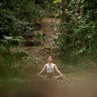 Hong Kong female yogi meditating in a forest