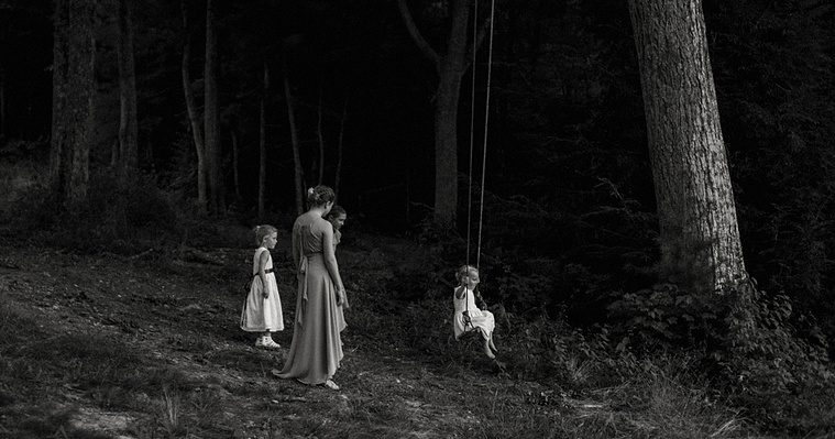 Kids playing on a swing near the wedding band during a lively celebration, captured by a Connecticut wedding photographer.