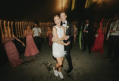 Couple dancing energetically on the dance floor at Lion Rock Farm in Litchfield County, captured by a lively Connecticut wedding photographer.