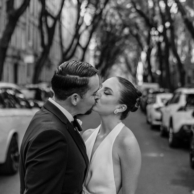 Kissing couple captured in black and white in Brooklyn, photographed by a Connecticut wedding photographer.