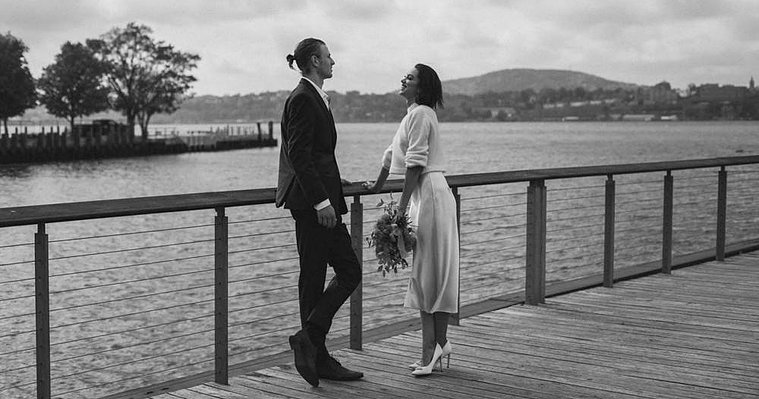 Bride and groom standing on a dock overlooking the Hudson River — captured by a CT-based wedding photographer.