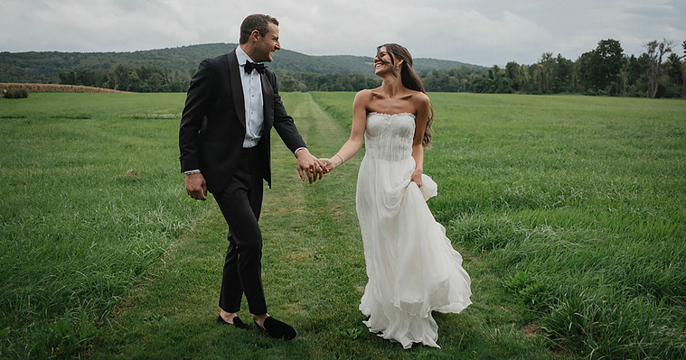 CT Wedding Photographer - Couple walking and laughing on a bright summer day at Lion Rock Farm in Connecticut, captured by a professional wedding photographer.