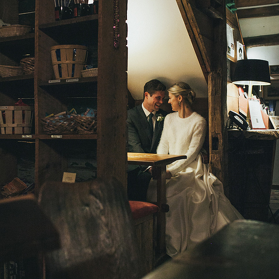 Couple sharing a quiet moment at night in a restaurant at Race Brook Lodge, Sheffield, Massachusetts — captured by a CT-based wedding photographer.