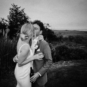 Fun, playful couple sharing a joyful moment together, full of laughter and natural energy, captured in a relaxed and candid style — photographed by a CT-based wedding photographer.