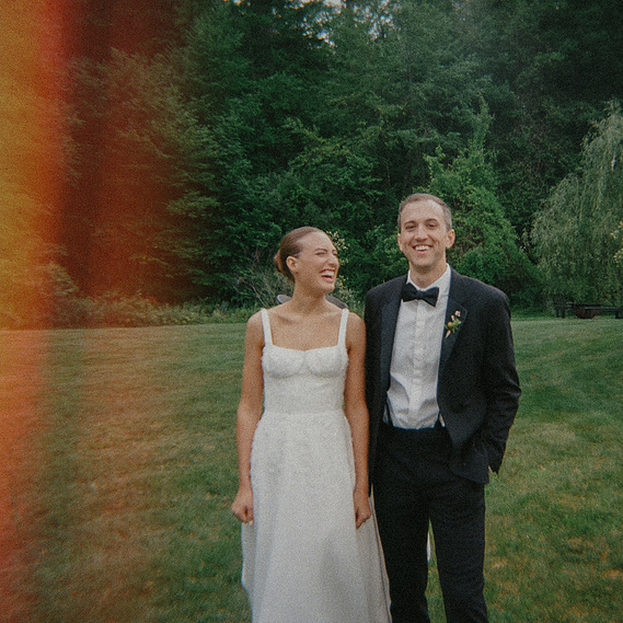 Bride and groom laughing at Foxfire Mountain House in the Catskill Mountains — 35mm film wedding photo with natural light leaks by a CT-based wedding photographer.