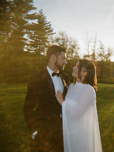 Bride and groom looking at each other happily at the Litchfield Inn in Litchfield, Connecticut — captured by a CT-based wedding photographer.