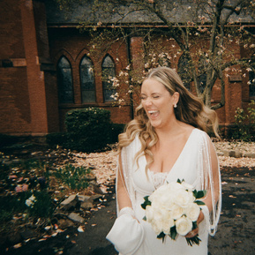 Bride laughing naturally in soft, flattering light, capturing a joyful and candid wedding moment with timeless elegance — photographed by a CT-based wedding photographer.