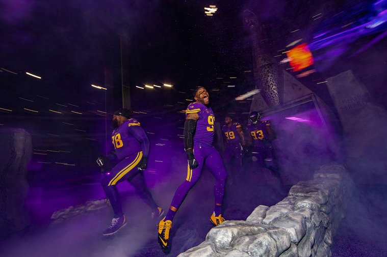 An image of Everson Griffen running on to the field shot by Minnesota Vikings team photographer Andy Kenutis.