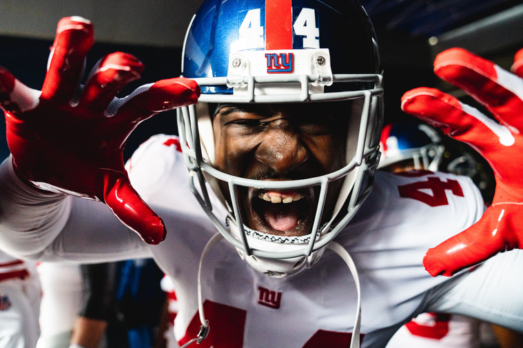 An image of a New York Giants photographer yelling at the camera shot by team photographer Matt Swensen.