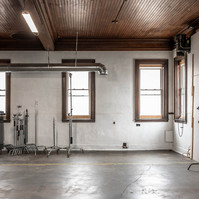 Interior view of photography and videography studio Enginehouse 27 located in Detroit, MI available for daily rental which includes, grip, lighting, capture cart, camera stand, lounge, generous space.