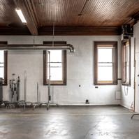 Interior view of photography and videography studio Enginehouse 27 located in Detroit, MI available for daily rental which includes, grip, lighting, capture cart, camera stand, lounge, generous space.