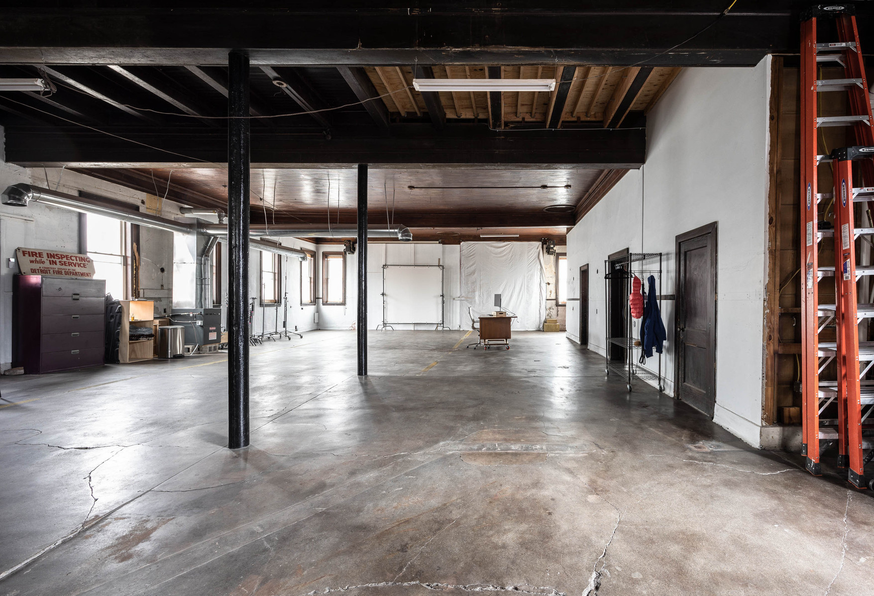 Interior view of photography and videography studio Enginehouse 27 located in Detroit, MI available for daily rental which includes, grip, lighting, capture cart, camera stand, lounge, generous space.
