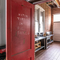 Interior view of photography and videography studio lounge at Enginehouse 27 located in Detroit, MI available for daily rental which includes, grip, lighting, capture cart, camera stand, lounge, generous space.