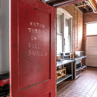 Interior view of photography and videography studio lounge at Enginehouse 27 located in Detroit, MI available for daily rental which includes, grip, lighting, capture cart, camera stand, lounge, generous space.