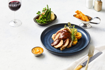 Roast and vegetables deconstructed displayed on a white bright background. Photographed by a professional food photographer for a business menu photography.