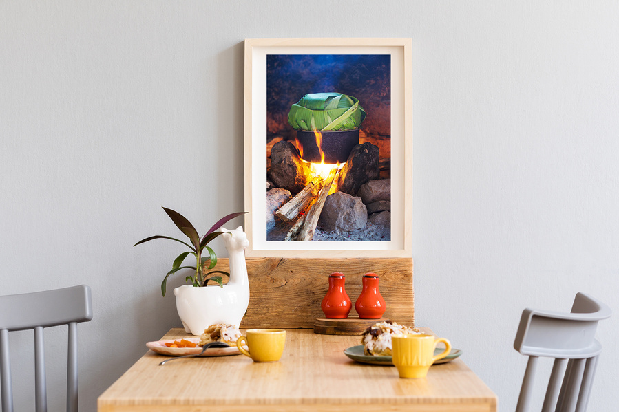 A fine art print of the he traditional Ugandan Luwombo stew, cooking over an open fire.