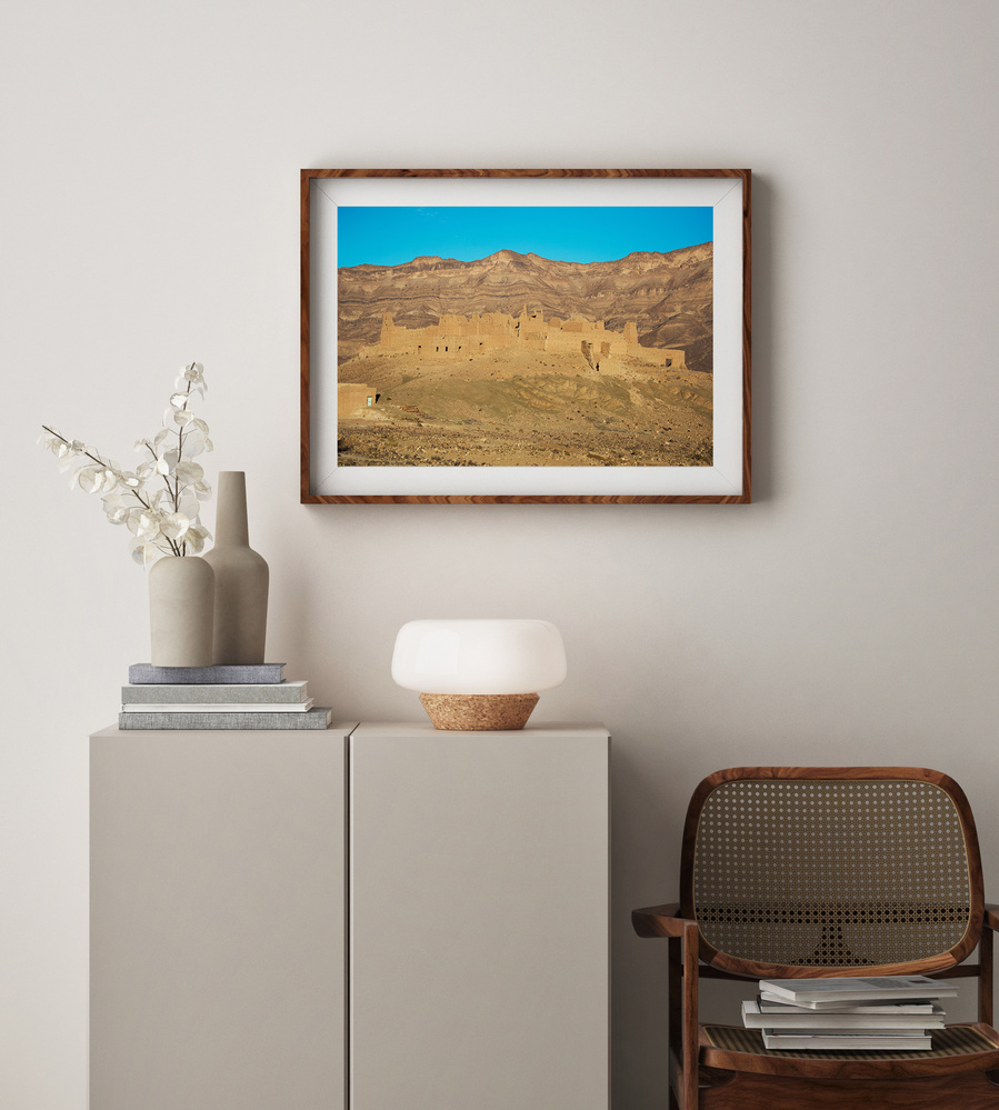 A fine art print of the landscape and architecture in the Draa Valley on a sunny day in Morocco.