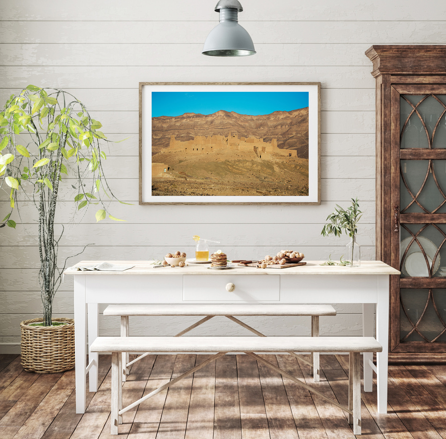 A large fine art print of the desert landscape and architecture in the Draa Valley on a sunny day in Morocco. 