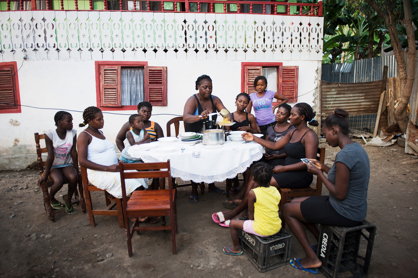 A mother serves dinner to her family in São Tomé and Principe. She cooked for the book 
