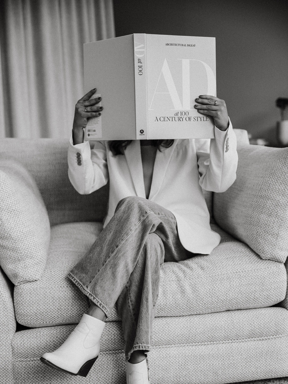 Interior designer reading book in branding photo at Sunday Furniture. The Good Design Group branding photography session with the best branding photographer in Calgary, Prairie West Creative.