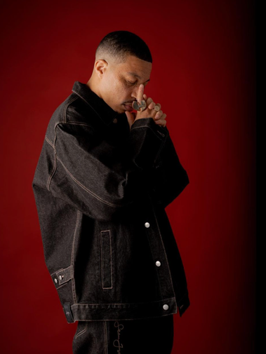 Stylized editorial portrait of Sean Brown wearing a black-and-tan coat, part of Bully Magazine’s Image Issue. Creative production by Rashaad Denzel.