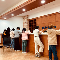No desks, poor things writing on the post office counter