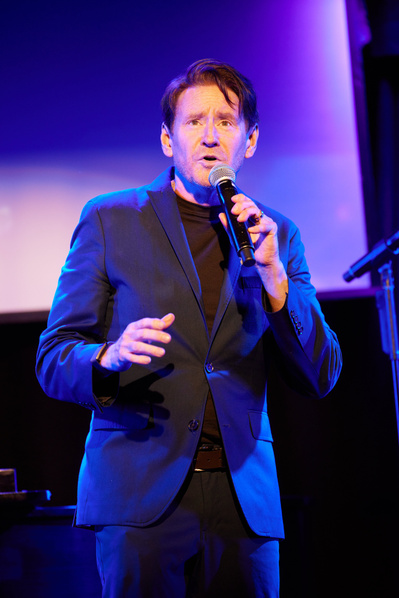 Close-ups of performers showcasing their vocal talents on stage.