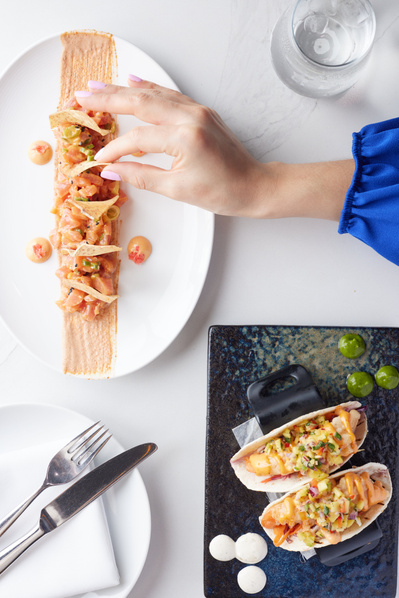 Editorial-style image of NYC chef plating gourmet dish.