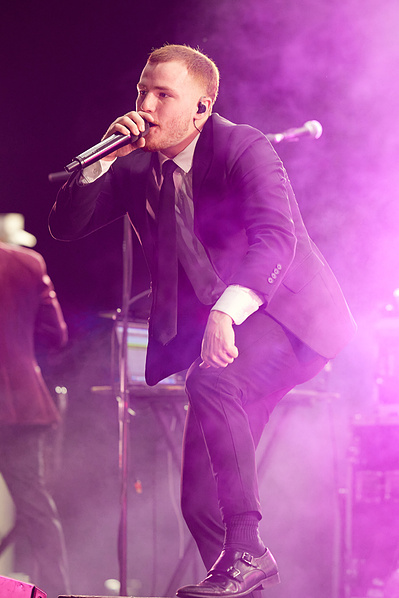 Passionate rock musicians in action on stage.