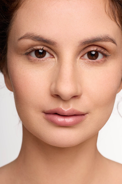 Campaign photos of model with glowing skin using NYC skincare brand.