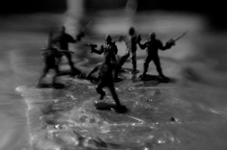 A black and white flipbook of a plastic soldier on fire and melting