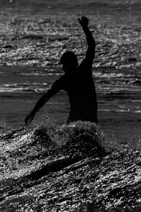 Surfer balancing on his board and it looks like he's flamenco dancing. Rockaway Beach Queens