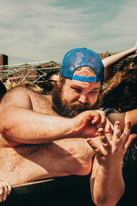 Chubby hipster counting his fingers as he&#x27;s enjoying a rock concert