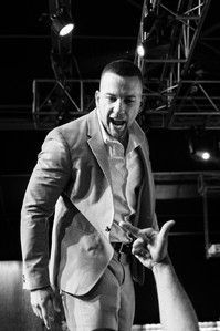 Charles Mason, the wrestler, yelling at a wrestling fan as the fan gives him the finger. 